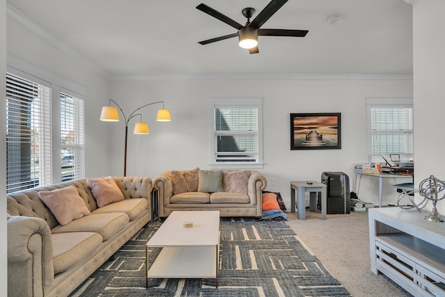 living area featuring crown molding, plenty of natural light, carpet floors, and ceiling fan