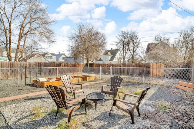 view of yard featuring a fenced backyard and an outdoor fire pit