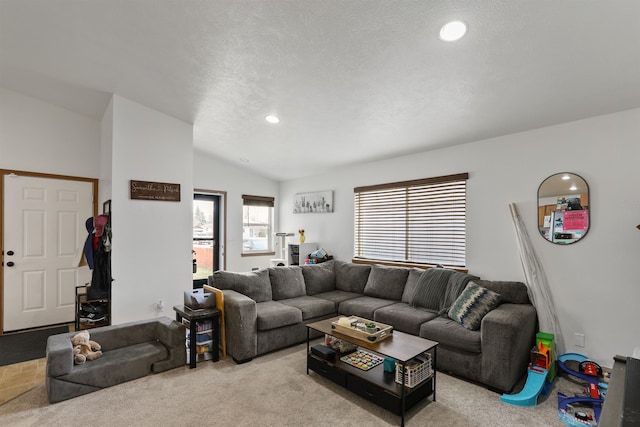 carpeted living room featuring lofted ceiling, recessed lighting, and a textured ceiling