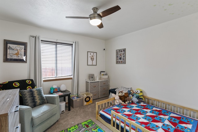 carpeted bedroom with a textured ceiling and ceiling fan