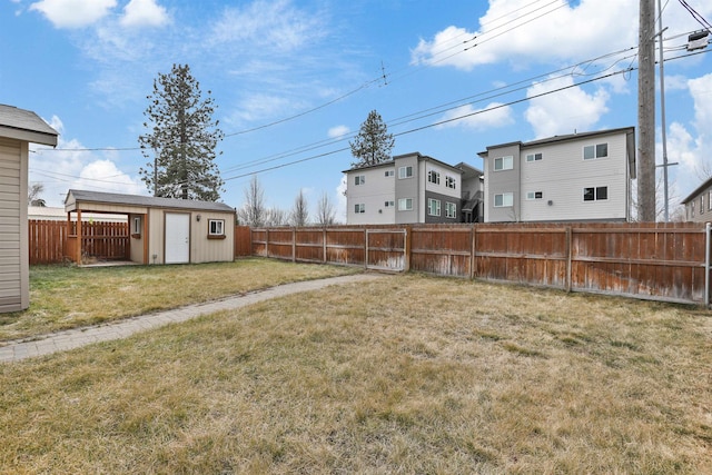 view of yard featuring an outdoor structure and a fenced backyard