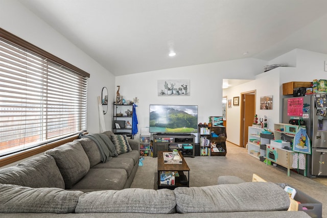 living room featuring carpet floors and vaulted ceiling