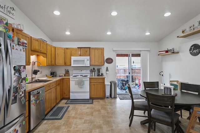 kitchen featuring light countertops, recessed lighting, appliances with stainless steel finishes, and a sink