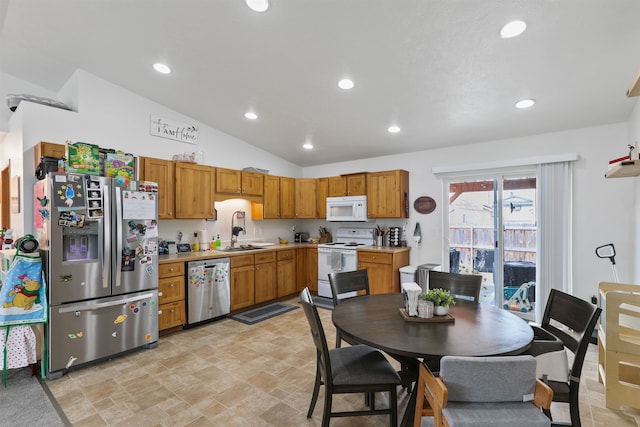 kitchen featuring a sink, recessed lighting, stainless steel appliances, light countertops, and lofted ceiling