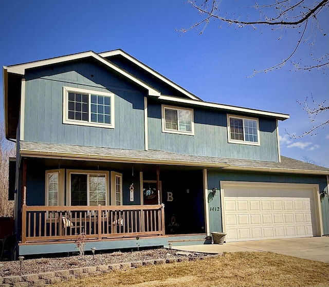 view of front of property with a garage, covered porch, driveway, and a shingled roof