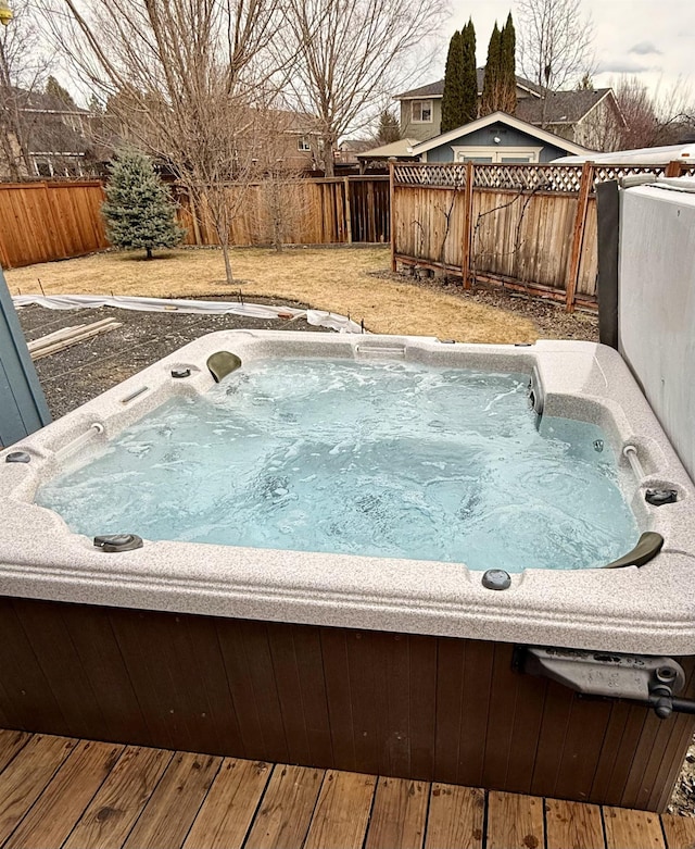 view of pool featuring a fenced backyard and a hot tub