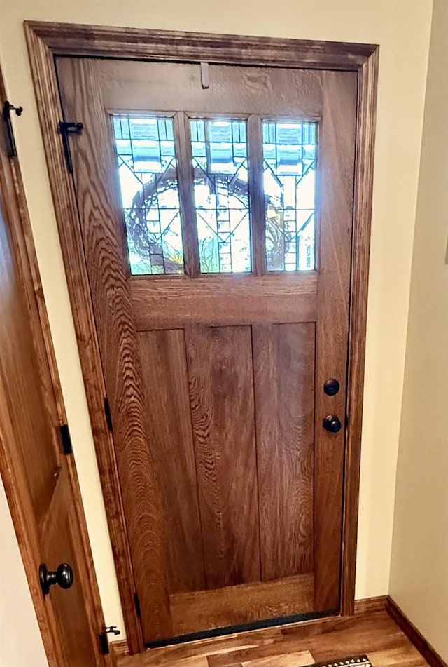 interior details with baseboards and wood finished floors