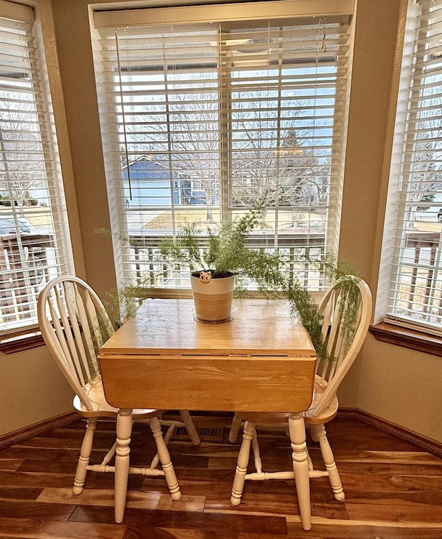 dining area featuring baseboards and wood finished floors