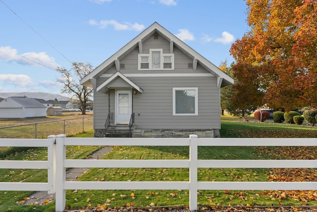 bungalow featuring a fenced front yard and entry steps