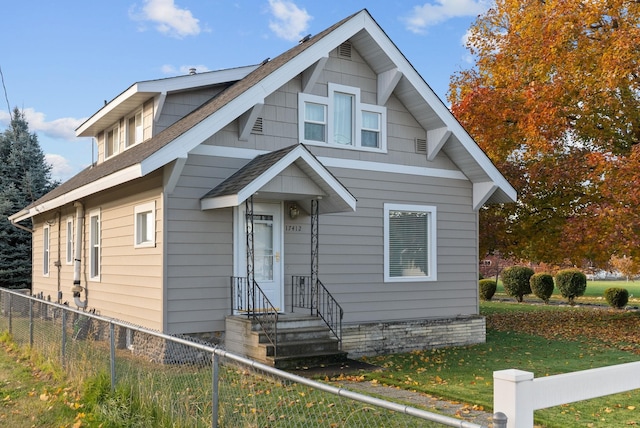 bungalow-style house featuring fence private yard and a front lawn