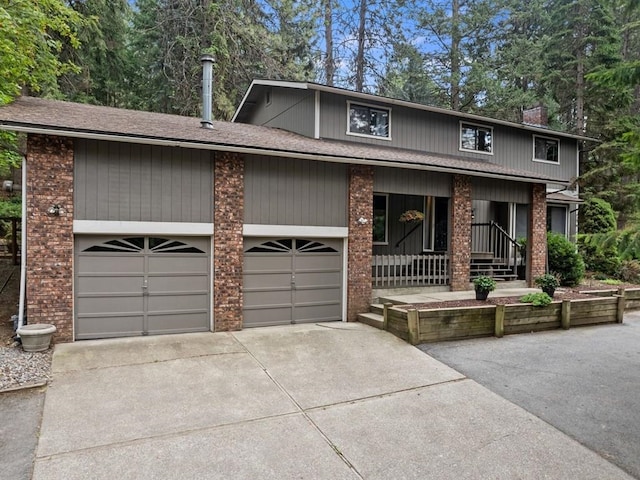 view of front of property featuring brick siding, a porch, and concrete driveway