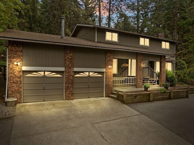 view of front facade featuring an attached garage, brick siding, and driveway