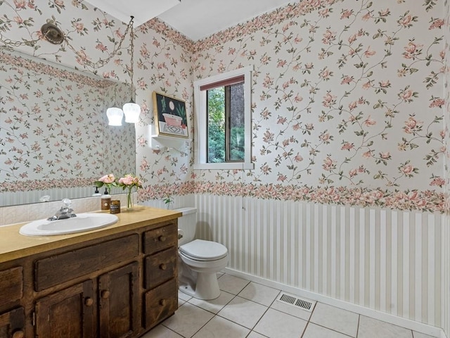 bathroom with wallpapered walls, toilet, visible vents, and tile patterned flooring