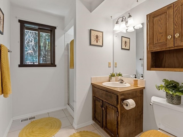 bathroom featuring vanity, visible vents, a shower with shower door, tile patterned flooring, and toilet