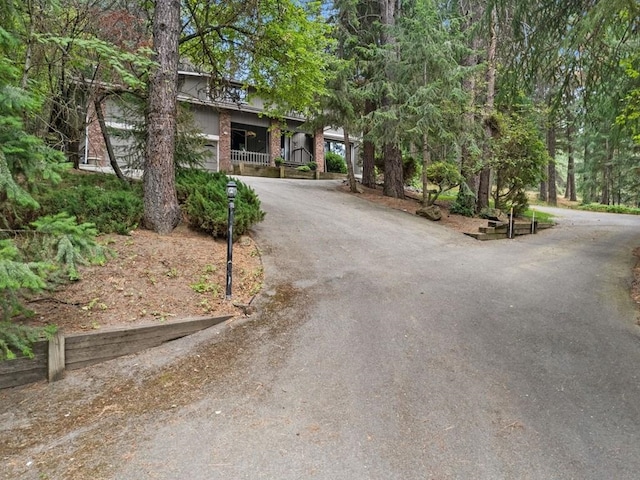 view of front of house featuring aphalt driveway and a porch