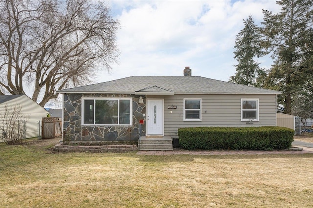 bungalow-style house featuring stone siding, a chimney, a front lawn, and fence