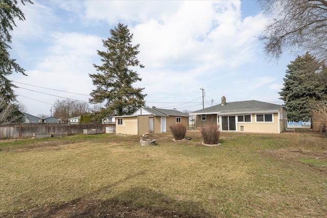 view of yard featuring an outbuilding and fence