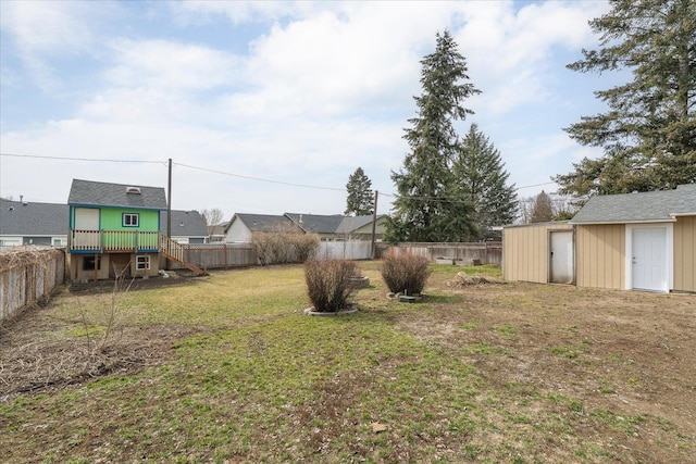 view of yard featuring an outbuilding, a storage unit, and a fenced backyard