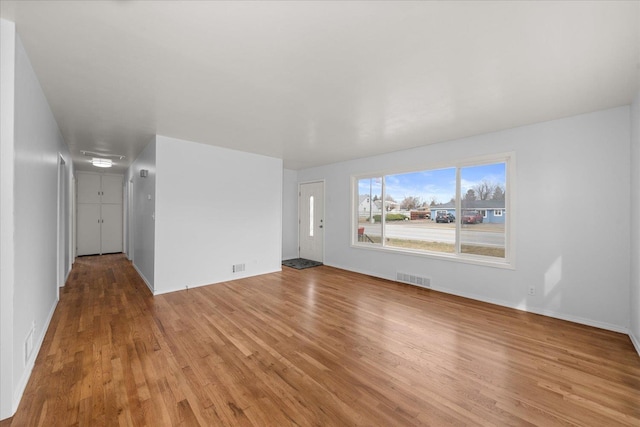 unfurnished room with visible vents and light wood-type flooring