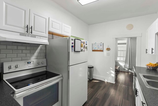 kitchen with range with electric cooktop, under cabinet range hood, freestanding refrigerator, decorative backsplash, and dark wood-style flooring