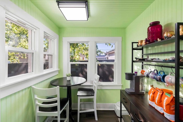 sunroom featuring vaulted ceiling and a healthy amount of sunlight