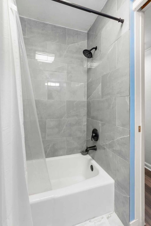 bathroom featuring shower / bath combo with shower curtain