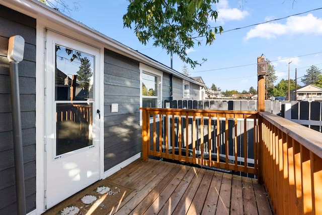 wooden terrace featuring fence