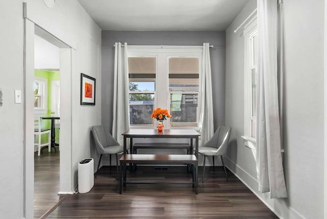 dining room with baseboards, dark wood-style flooring, and breakfast area