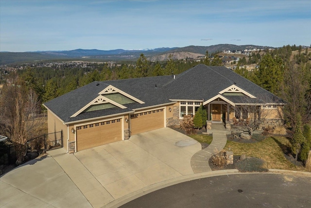 view of front facade featuring stone siding, an attached garage, and concrete driveway