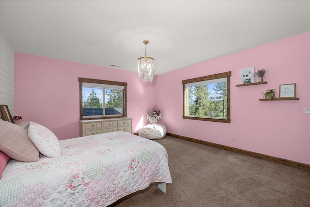 bedroom with a notable chandelier, baseboards, and carpet