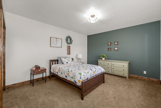 bedroom with baseboards and light carpet