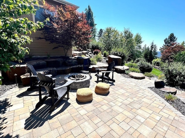 view of patio / terrace featuring an outdoor fire pit