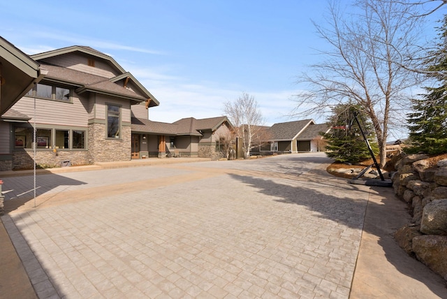 view of road with decorative driveway