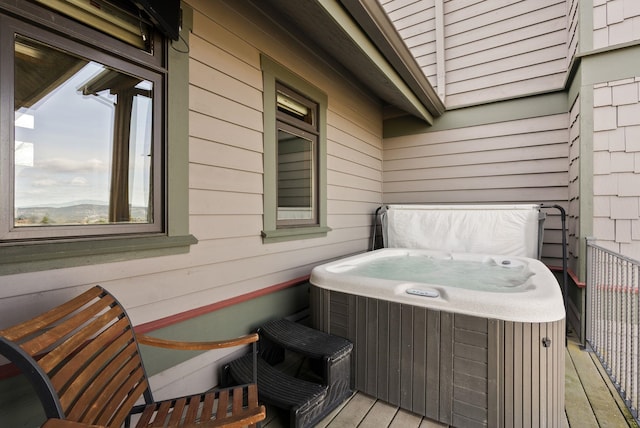 wooden terrace with a hot tub