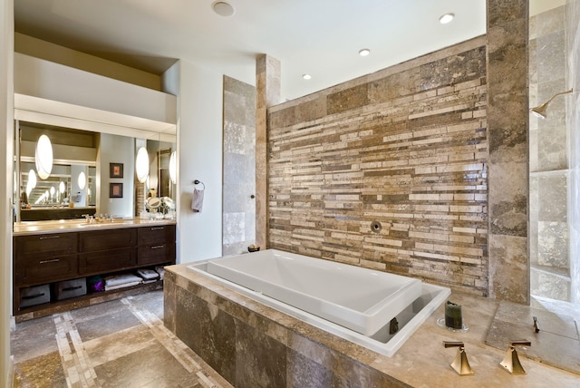 full bath featuring a bath, recessed lighting, and vanity