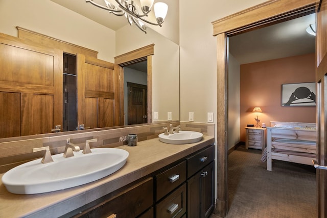 bathroom with double vanity, backsplash, an inviting chandelier, and a sink