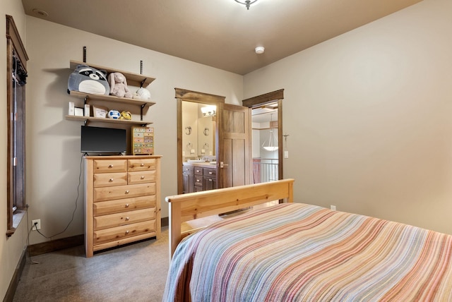 carpeted bedroom with baseboards and ensuite bathroom