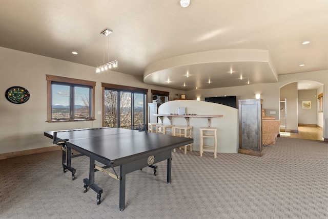 game room featuring recessed lighting, carpet, arched walkways, and baseboards