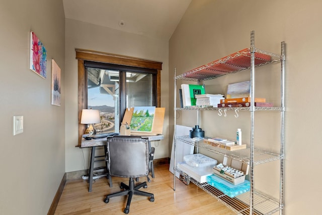 home office with baseboards and wood finished floors