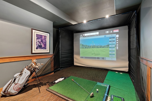 game room with golf simulator and wood finished floors