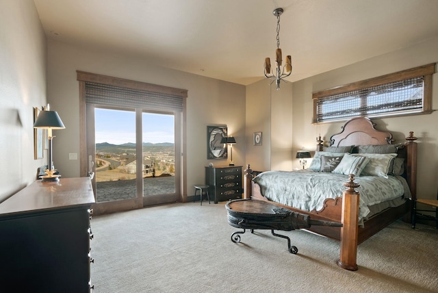 bedroom featuring a chandelier, carpet, and access to exterior