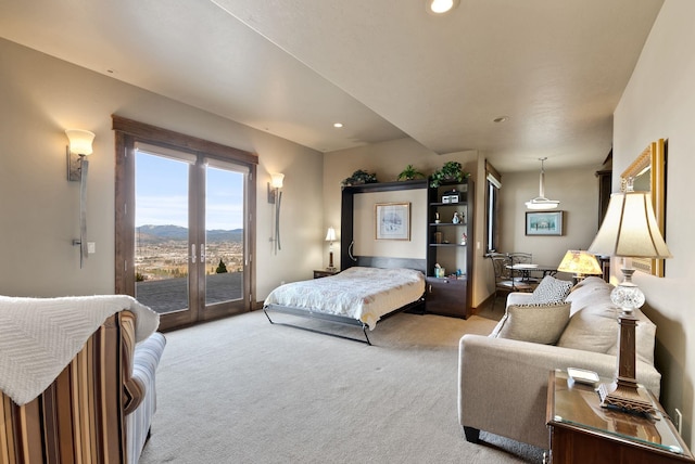 bedroom with access to exterior, light colored carpet, recessed lighting, french doors, and a mountain view