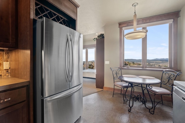 dining space featuring a wealth of natural light and baseboards