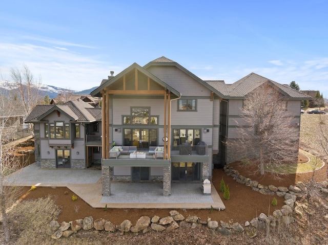 back of property featuring a patio area and a balcony