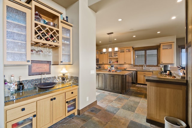 kitchen with light brown cabinets, a sink, stone tile flooring, recessed lighting, and decorative backsplash