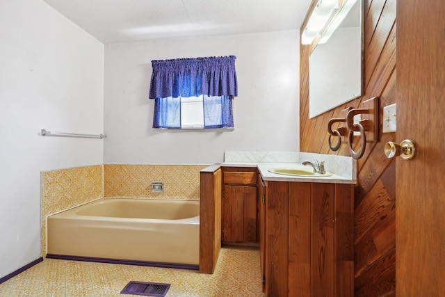 full bath featuring vanity, tile patterned floors, a bath, and visible vents