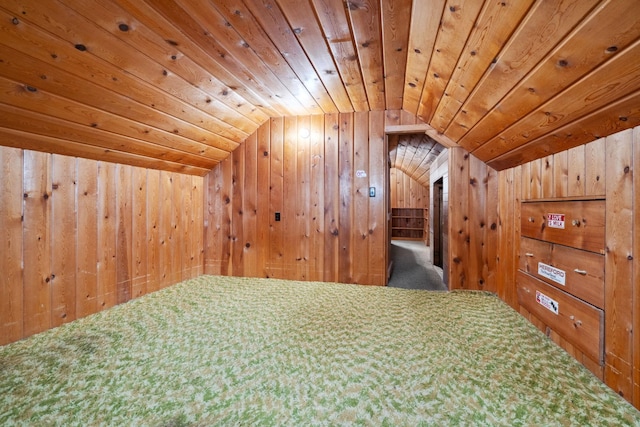 additional living space with wooden walls, wooden ceiling, and vaulted ceiling