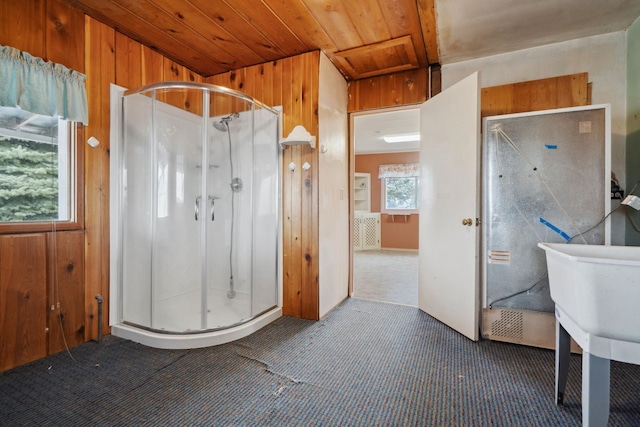 bathroom featuring a shower stall, wood ceiling, and wood walls