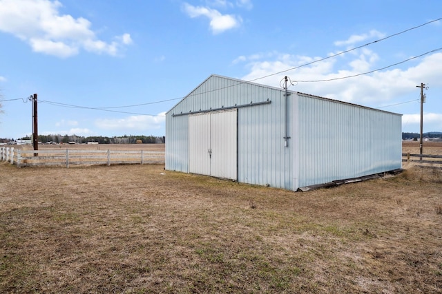 view of pole building with fence