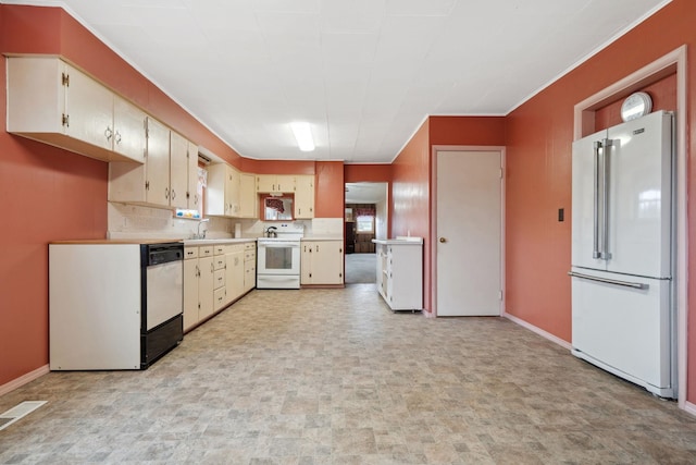 kitchen with white appliances, light countertops, baseboards, and a sink